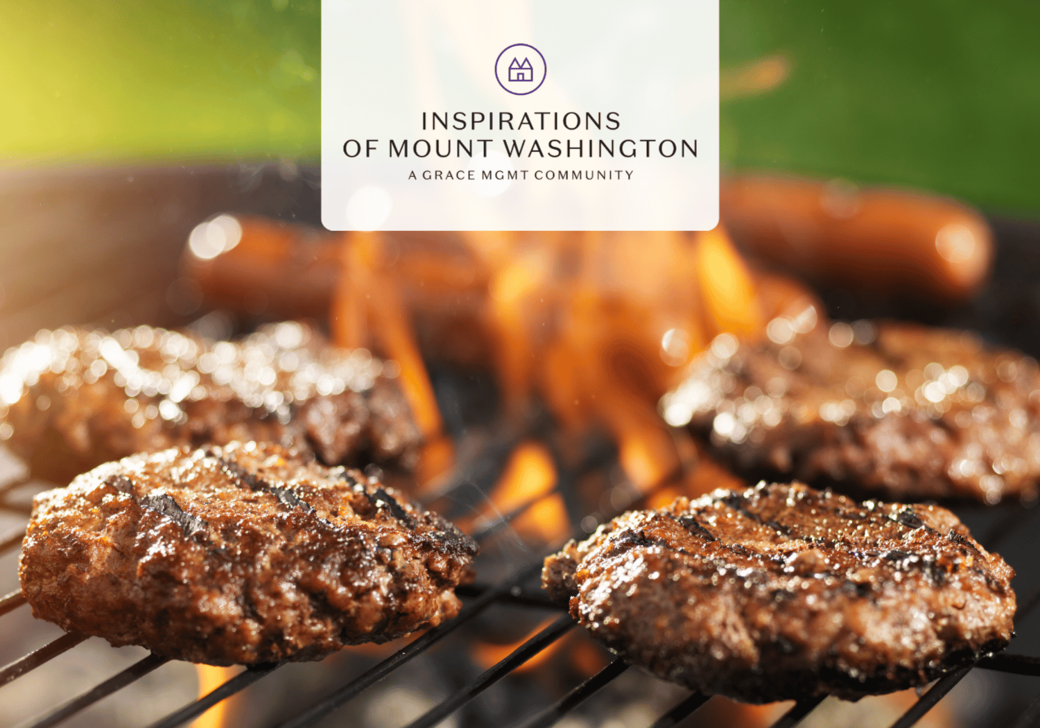Close-up of beef burgers grilling over an open flame with a centered white promo card reading 'INSPIRATIONS OF MOUNT WASHINGTON A GRACE MGMT COMMUNITY'.